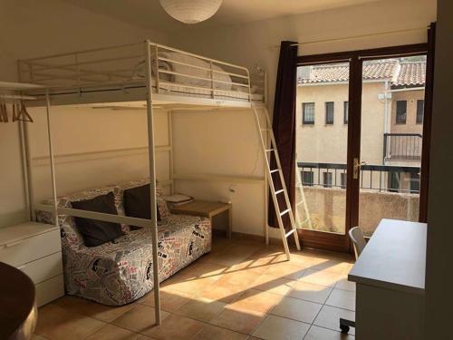 une chambre avec deux lits superposés et une fenêtre dans l'établissement Studio avec balcon - Plage à 10min à pied, au Pradet