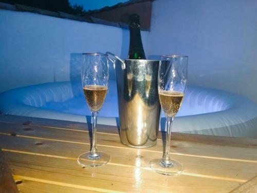 a table with two glasses of wine and a bottle at Casa Valle del Hontanar in Cardenete