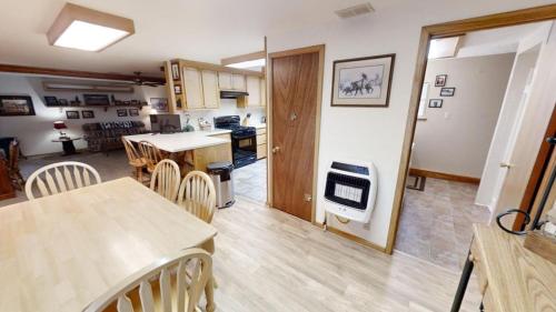 a kitchen and living room with a table and chairs at Roberts Trappers Lodge - Pet Friendly - WiFi- Trailer Parking - Garage Access - Washer - Dryer - Great Views in Red River