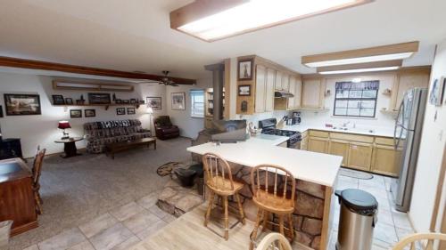 a kitchen and living room with a table and chairs at Roberts Trappers Lodge - Pet Friendly - WiFi- Trailer Parking - Garage Access - Washer - Dryer - Great Views in Red River