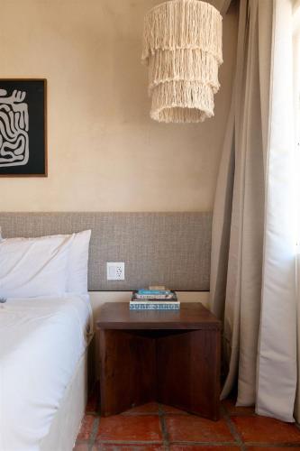 a bedroom with a bed and a nightstand next to a table at Sand Castle in Imperial Beach