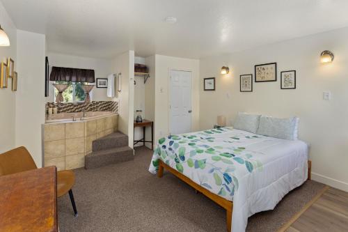 a bedroom with a bed and a bathroom with a sink at Wheeler on the Bay Lodge and Marina in Wheeler