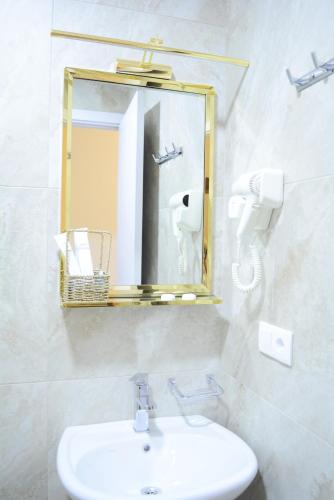 a bathroom with a sink and a mirror at Hotel Tabernei in Tbilisi City