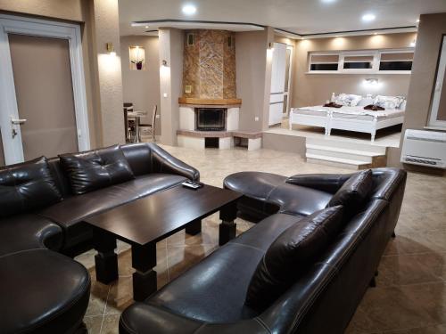 a living room with a couch and a table and a bed at Black Sea Pearl in Chernomorets