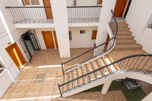 a spiral staircase in a building with wooden floors at Hotel Salvatierra in La Paz