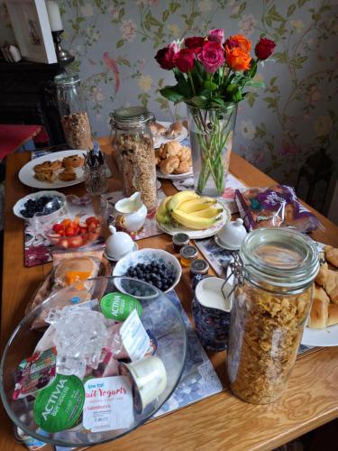 a table with food and flowers and jars of food at Low Gingerfield Farm B&B in Richmond