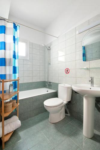 a bathroom with a toilet and a sink and a tub at Welcome! Perfect Location-City Center in Larnaca