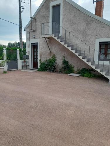 a house with a staircase on the side of it at Maison proche le PAL 4kms in Thiel-sur-Acolin