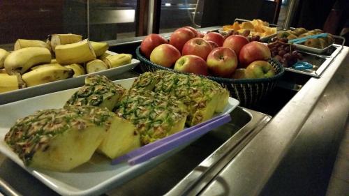 a buffet with a plate of fruit on a table at Hotell Centralstation in Uppsala