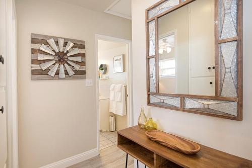 a bathroom with a mirror and a wooden table at 118 Emerald Ave A & B in Newport Beach