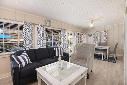 a living room with a couch and a table at 118 Emerald Ave A & B in Newport Beach