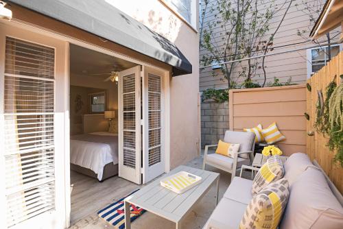 a small patio with a bed and a table at 118 Emerald Ave A & B in Newport Beach