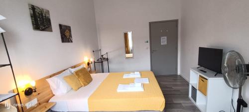a small room with a bed and a tv at Seaside House in Ponta Delgada