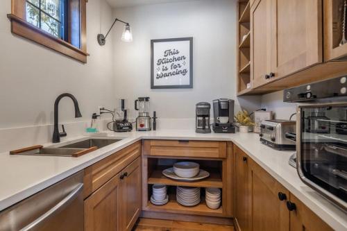 a kitchen with a sink and a counter with dishes at Suncadia 7 Bdrm Home with Hot Tub Overlooking Golf Course in Cle Elum