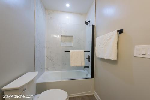 a bathroom with a shower and a toilet and a sink at LUX 3BR Apartment in DC with Rooftop in Washington, D.C.