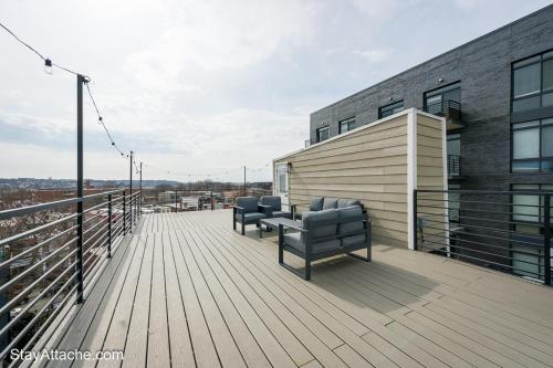 a deck with two couches on top of a building at LUX 3BR Apartment in DC with Rooftop in Washington, D.C.