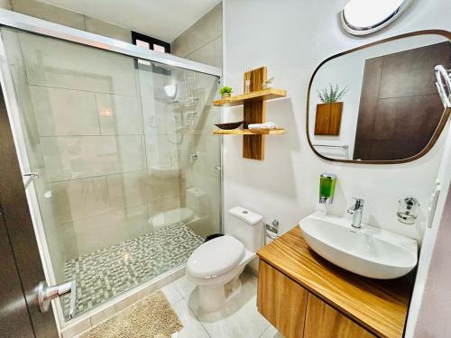 a bathroom with a shower and a toilet and a sink at moderno con alberca cerca de la playa by G P S rentas in Mazatlán