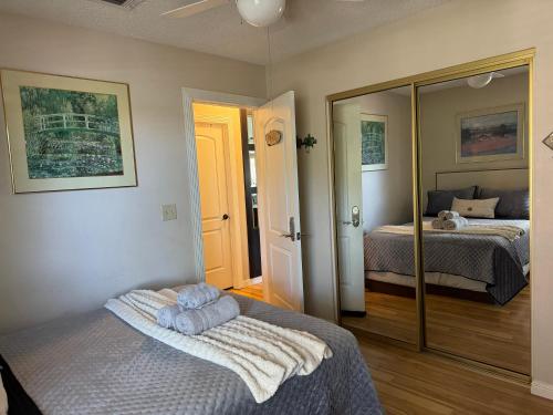a bedroom with two beds and a mirror at The Monet- One bedroom with a private entrance - shared bathroom in Las Vegas
