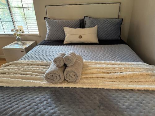 a bedroom with a bed with towels on it at The Monet- One bedroom with a private entrance - shared bathroom in Las Vegas
