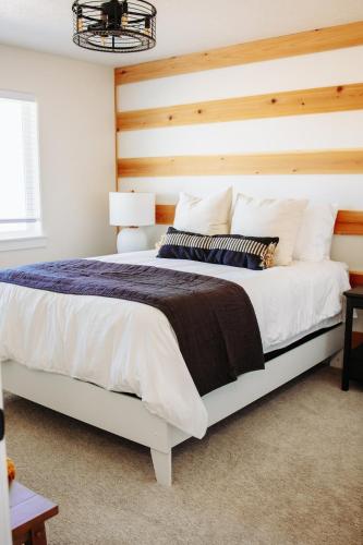 a bedroom with a large bed with a wooden headboard at Creekside Cabins Hickory Stay w views near Lava in McCammon