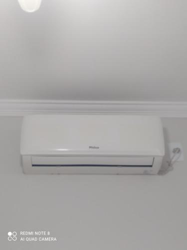 a white air conditioner sitting on top of a ceiling at Pousada Quarto Privativo a 600 mts da basílica nova in Aparecida