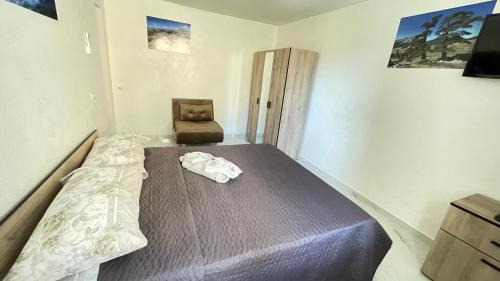 a bedroom with a bed and a chair in it at L'oasi del raganello in Civita