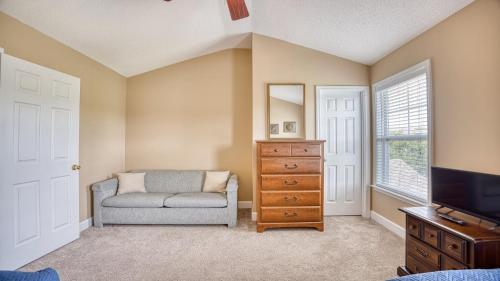 a living room with a couch and a television at 511 Heron Bay in Briarwood