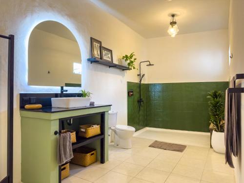 a bathroom with a shower and a sink and a toilet at Umalas Retreat - Private Villa with Cook in Kerobokan
