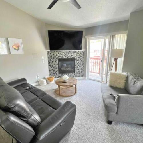 a living room with a couch and a fireplace at Private Stylish Townhome near ISU & Hospital in Pocatello