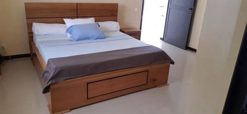 a bedroom with a large bed with a blue pillow at Villa 3 patios in Somone