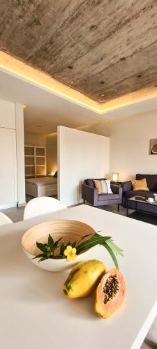 a white table with a plate of food on it at Papaya Apartments Sal Island in Santa Maria