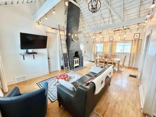 a living room with a couch and chairs and a table at Whitewater Cottage- IN TOWN walk to everything in Lava Hot Springs