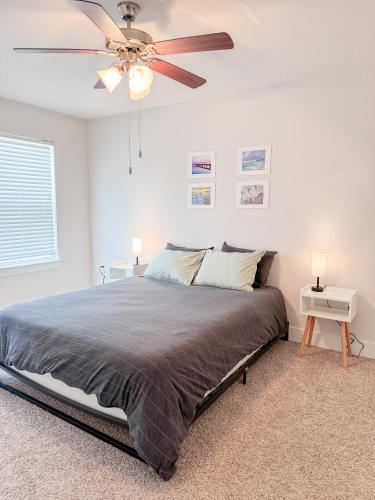 a bedroom with a bed and a ceiling fan at morii - townhome with pool in Pensacola