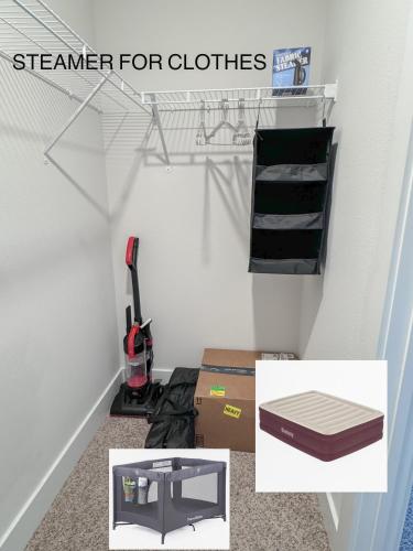 a room with a closet with a vacuum and boxes at morii - townhome with pool in Pensacola