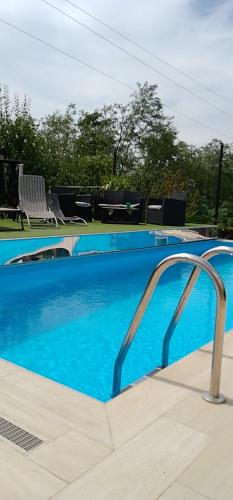 a swimming pool with blue water at Smestaj sa bazenom Sunny Hill in Smederevska Palanka