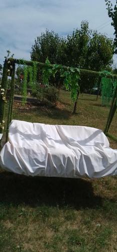 a white sheet on a bench in a field at Smestaj sa bazenom Sunny Hill in Smederevska Palanka