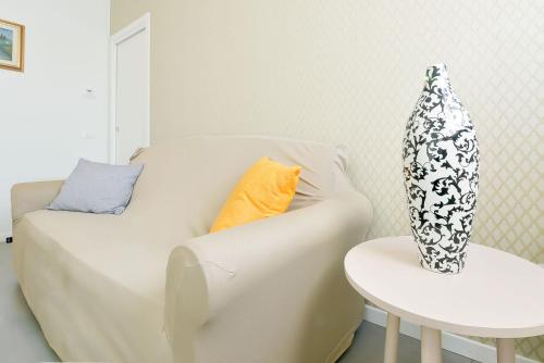 a white couch with a table and a vase on it at Queen Venice Fly Apartments in Campalto