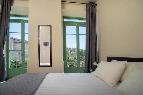 a bedroom with a bed and a large window at Ancient Agora Plaka in Athens