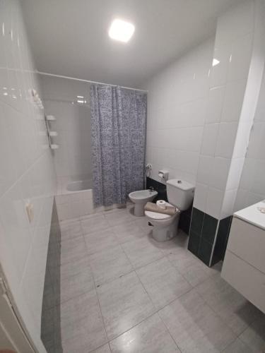a bathroom with two toilets and a shower and a sink at Relax playa blanca in Playa Blanca