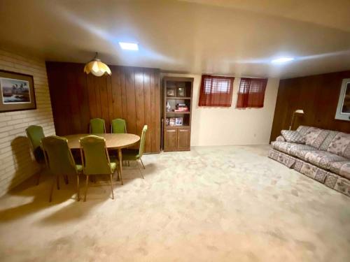 a living room with a table and chairs and a couch at Roomy Midtown Home-Large and Central to Everything in Pocatello