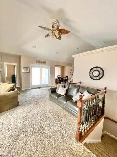 a living room with a couch and a ceiling fan at Spacious open home near hospital and university in Pocatello