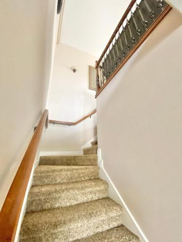 a staircase in a home with white walls at Spacious open home near hospital and university in Pocatello
