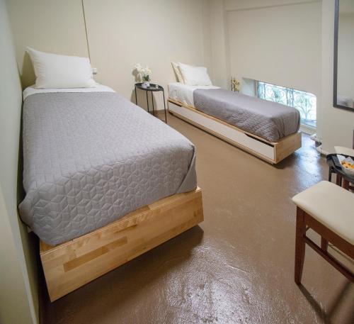 two twin beds in a room with at Ancient Agora Plaka in Athens