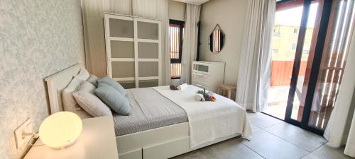 a bedroom with a bed and a large window at Papaya Apartments Sal Island in Santa Maria