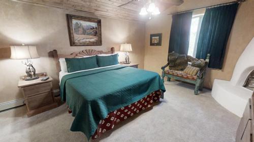 a bedroom with a large bed and a chair at River Ritz - Pet Friendly - WiFi - Near the Ski Area - Fireplace - On the River - Washer - Dryer - in Red River