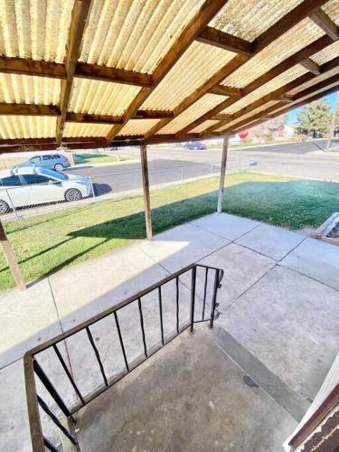 a porch with a bench under a wooden roof at Comfy Pocatello home-central to park and grocery in Pocatello