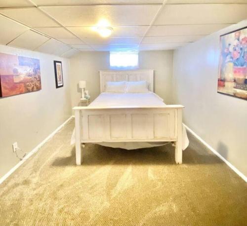 a bedroom with a white bed in a room at Comfy Pocatello home-central to park and grocery in Pocatello