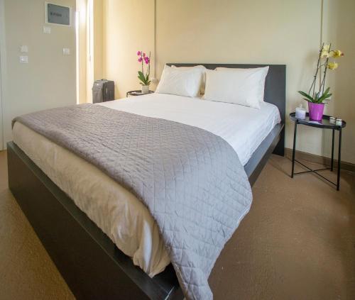 a bedroom with a large bed with white sheets and pillows at Ancient Agora Plaka in Athens