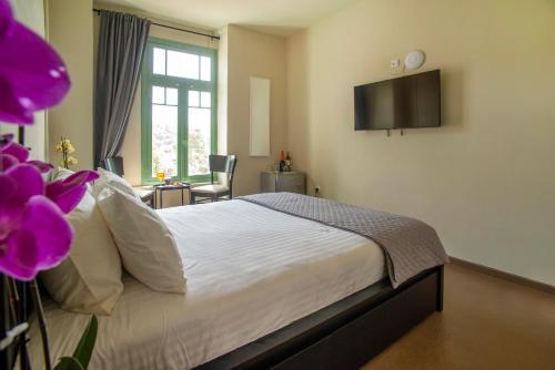 a bedroom with a bed with a tv on the wall at Ancient Agora Plaka in Athens