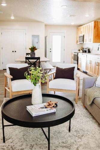 a living room with a coffee table and a kitchen at Creekside Cabin Magnolia stay w views and hot springs ONE br in McCammon